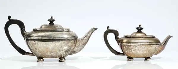 A graduated pair of Regency style silver teapots, one William Hutton & Sons, date letter rubbed, one H Matthews, Birmingham 1908, rounded oblong, with