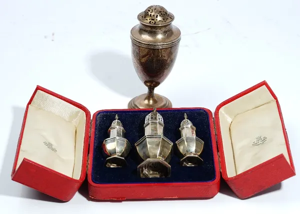 A cased set of three George I style silver octagonal caster and pepperettes, Jays, Chester 1909, 9.5cm & 13cm high and a George III style shaped silve