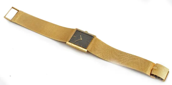 An Eterna 18ct gold rectangular cased gentleman's bracelet wristwatch, the signed black dial with gilt baton numerals and with gilt hands, on a taperi