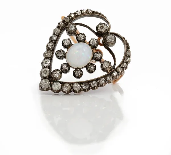 A late Victorian opal and diamond set brooch of openwork heart design, the central oval opal cabochon in a surround of circular cut diamond within an