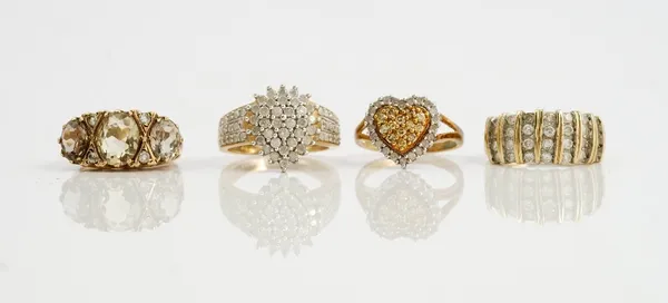 A collection of three 9ct gold and diamond set dress rings comprising a diamond and coloured diamond heart shaped dress ring, ring size L; another of