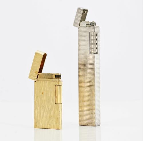 A Dunhill silver plated rectangular gas lighter, detailed Dunhill, Made in Switzerland, length 12.5cm and a Madison Caran D'Ache gilt metal rectangula