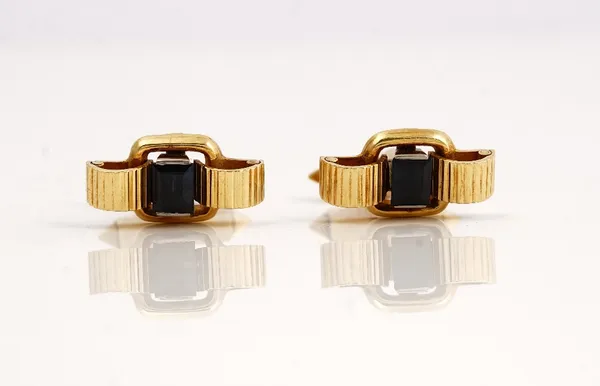 A pair of 18ct gold and sapphire dress cufflinks, each mounted with a rectangular emerald cut sapphire to the centre between ridged sides, the backs w