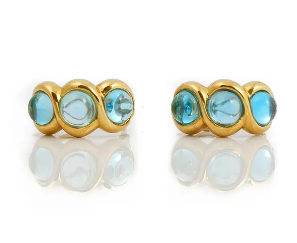 A pair of two colour gold and cabochon aquamarine three stone earclips, each mounted with a row of three circular cabochon aquamarines within twisted