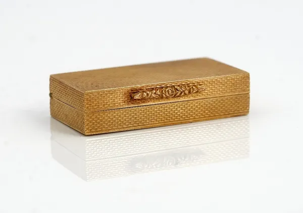 A 9ct gold rectangular hinge lidded pill box, retailed by Dunhill London, the exterior engine turned, initial engraved within the lid and with a flora