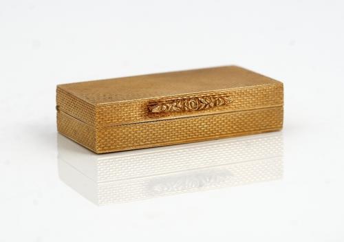 A 9ct gold rectangular hinge lidded pill box, retailed by Dunhill London, the exterior engine turned, initial engraved within the lid and with a flora