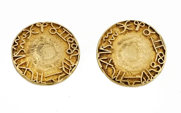 A pair of yellow precious metal dress studs, applied with zodiac symbols, to a textured ground, weight 11.4gms.