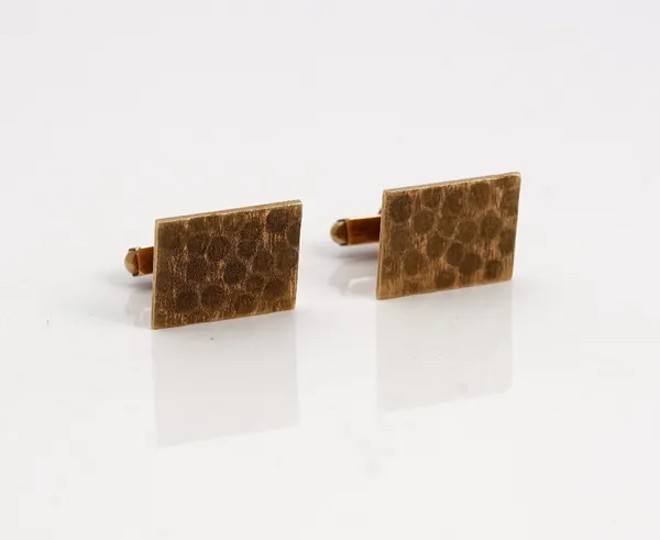 A pair of 9ct gold cufflinks, each with a rectangular front, having a textured finish, the backs with folding bar fittings, London 1969, gross weight