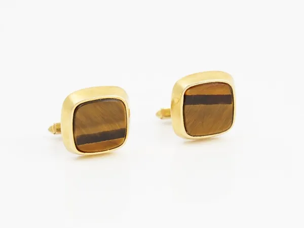 A pair of 9ct gold mounted tiger's eye cufflinks, each with a curved square front, the backs with folding bar fittings, London 1981, gross weight 10.8