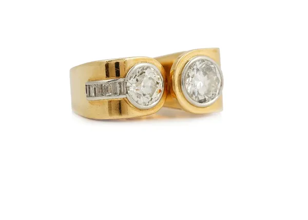 A Robert Kunz gold and diamond cocktail style ring, collet set with two graduated cushion shaped diamonds and with a curved row of six baguette diamon