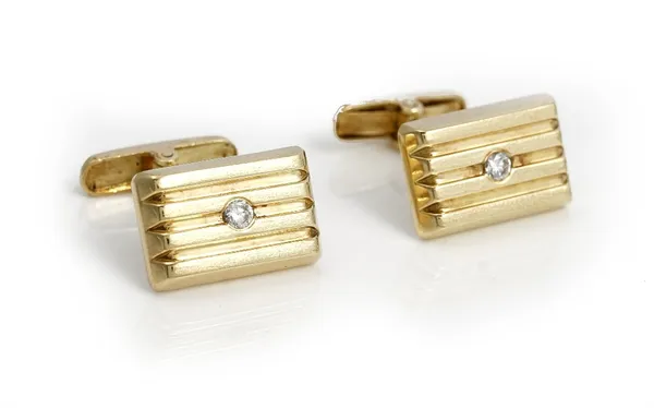 A pair of gold and colourless gem set cufflinks, the rectangular fronts with ridged decoration and with folding bar fittings at the backs, detailed 58