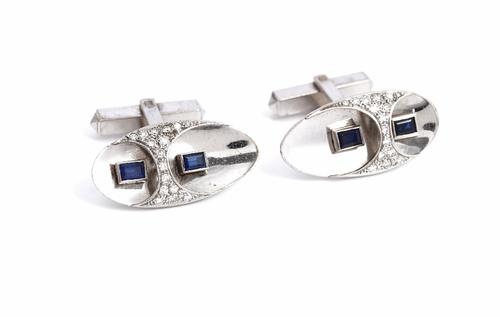 A pair of white gold, diamond and blue gem set dress cufflinks, with oval fronts, mounted with circular cut diamonds and with rectangular cut blue gem