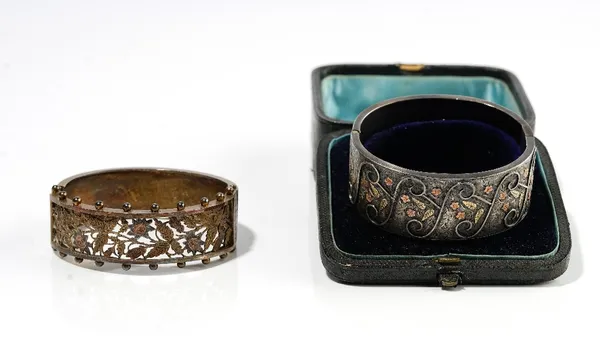 A Victorian silver oval hinged bangle, the front with floral and foliate pierced and engraved decoration, between beaded sides, on a snap clasp, Birmi