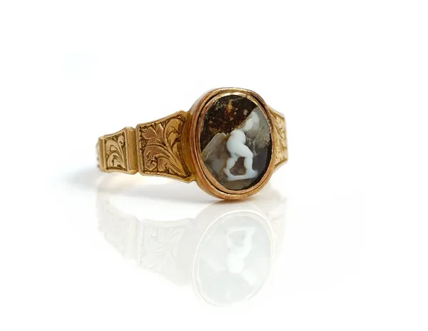 A Victorian gold and oval cameo ring, the mount decorated with engraved tapered panels, (the central cameo badly damaged), circa 1850, ring size K and