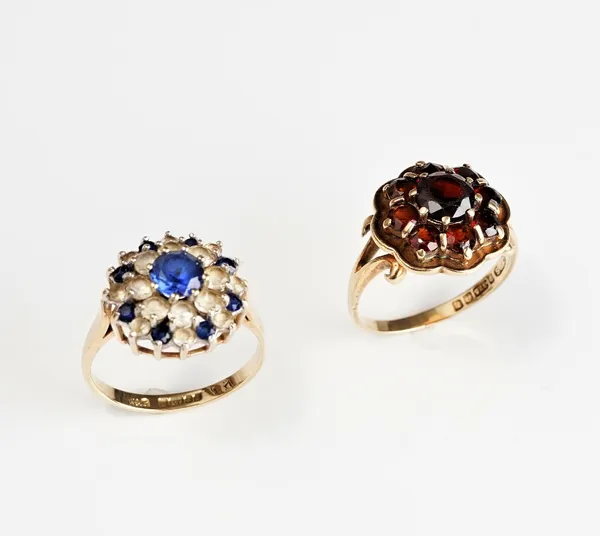 A 9ct gold and garnet set nine stone cluster ring, ring size N and a 9ct gold, blue and colourless gem set cluster ring, ring size N and a half, gross