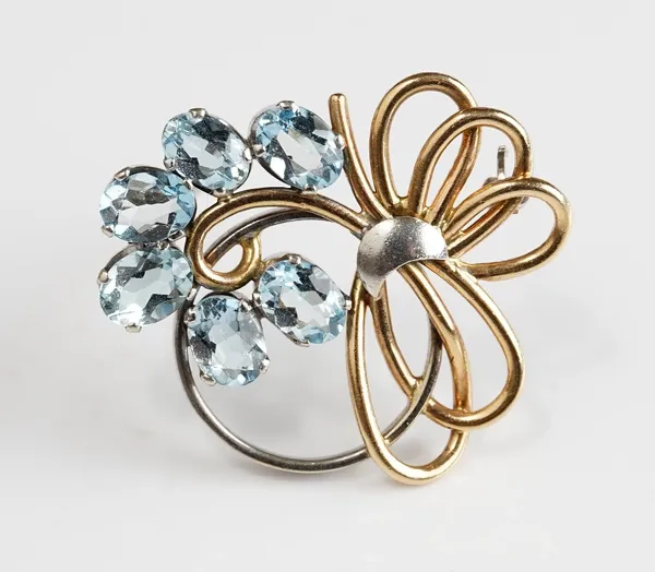 A 9ct gold two colour gold and aquamarine brooch, in an openwork design, claw set with six oval cut aquamarines, London 1954, gross weight 5.6 gms.