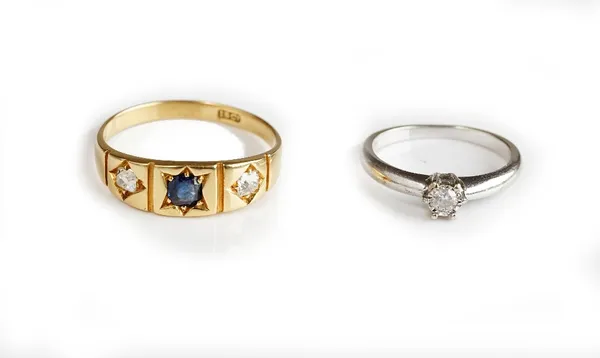 A gold, sapphire and diamond three stone ring, star gypsy set with a cushion shaped sapphire between two cushion shaped diamonds, detailed 18 CT, ring