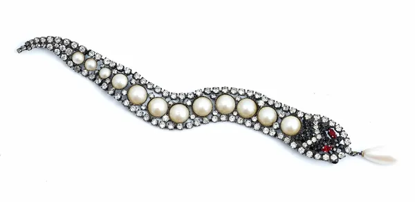 A Butler & Wilson red and colourless paste and imitation pearl brooch designed as an articulated snake, the mouth with a drop shaped pendant imitation