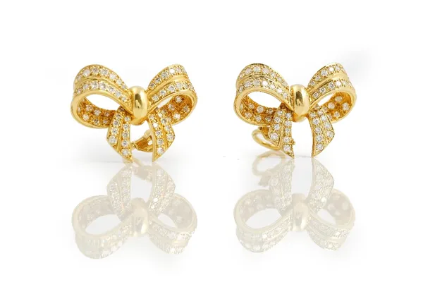 A pair of 18ct gold and diamond earclips, each designed as a ribbon tied bow, mounted with circular cut diamonds, with post and folding clip fittings