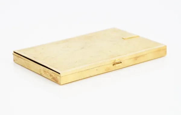 A gold rectangular visiting cards case, having a textured finish, two sprung clip fittings within, detailed Manning 18 K, the exterior with a sliding