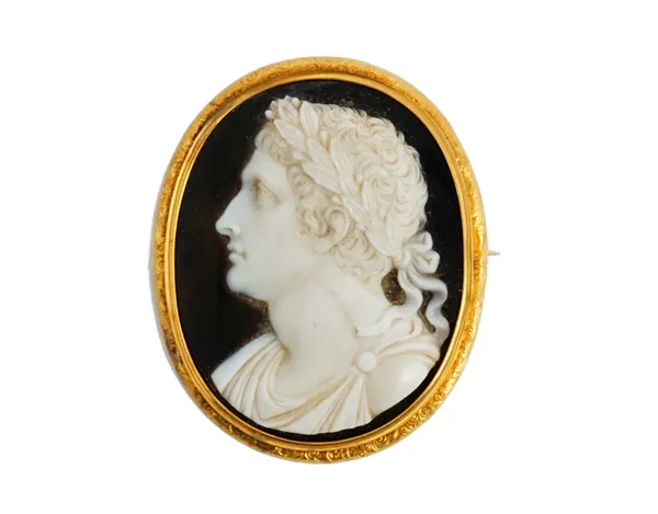 A 19th Century banded agate carved cameo and yellow precious metal mounted brooch of oval design, carved with the head and shoulder bust of a roman ge