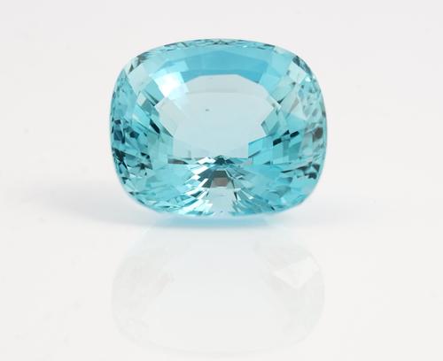 An unmounted cushion cut aquamarine, weight approximately 48cts, displayed in a box.