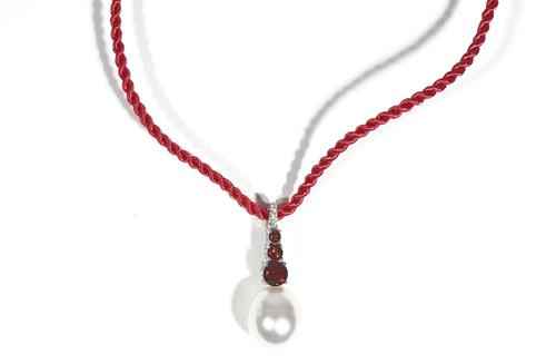 A white gold, garnet, diamond and cultured pearl pendant necklace by Autore, the openwork pendant set with three circular-cut diamonds above a three g