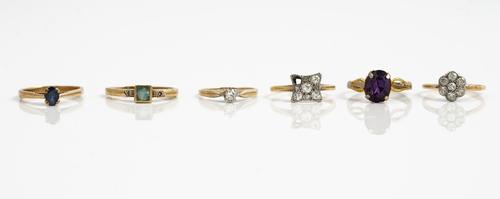 A gold and diamond seven stone cluster ring, detailed 18ct, a gold and diamond single stone ring, detailed 585, a gold and diamond set curved square c