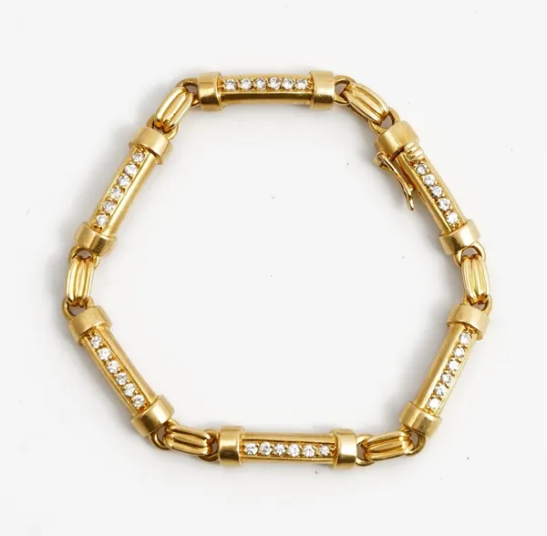 A French gold and diamond bracelet, formed as a row of curved baton shaped links, mounted with rows of circular cut diamonds, on a snap clasp with a f