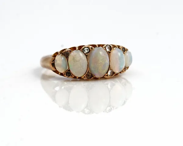 A late Victorian 9ct gold and opal five stone ring, mounted with a row of opals graduating in size to the centre, Birmingham 1897, gross weight 3 gms,