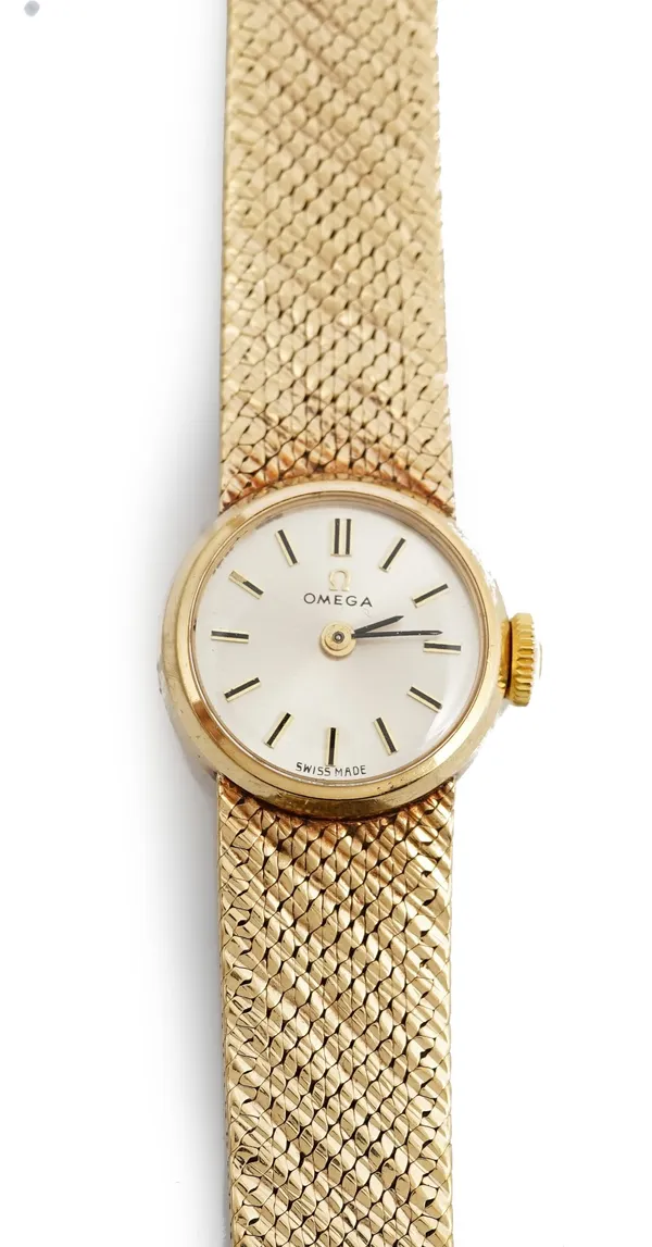An Omega 9ct gold lady's bracelet wristwatch, the signed silvered dial with baton numerals and with black hands, on a tapered woven link bracelet, wit