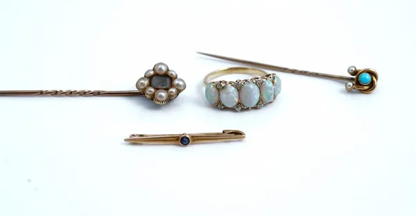 A gold, opal and diamond ring, mounted with a row of five graduated oval opals and with four pairs of cushion shaped diamonds, mounted at intervals, u
