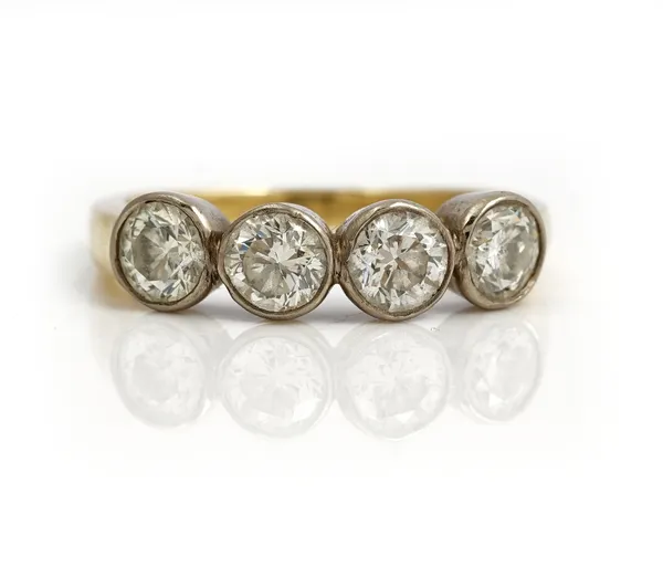 A gold ring, collet set with a row of four circular cut diamonds, apparently unmarked, ring size Q, gross weight 4.8 gms.
