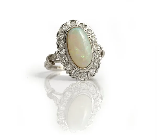 A white gold, opal and diamond set oval cluster ring, collet set with the oval opal at the centre, in a surround of circular cut diamonds, detailed 58