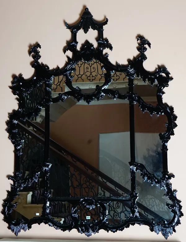 A high gloss black finish overmantel mirror, in Chinese Chippendale taste, of shaped outline, with divided plates, 150cm wide x 200cm high.
