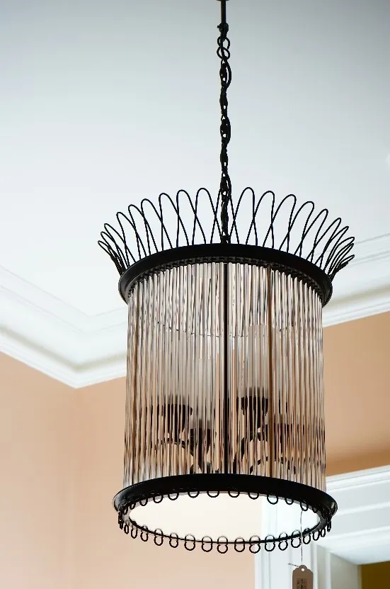 A cylindrical black metal and tubular glass pendant light fitting, of four lights, 50cm high.