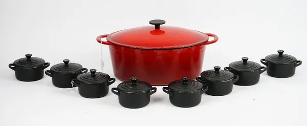 A Molten red casserole dish and eight individual Le Creuset black petit casserole dishes(9).