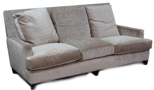 A contemporary three seat sofa, upholstered in a beige scrunched velvet with loose back seat cushions, on ebonised legs, 207cm wide x 96cm high.