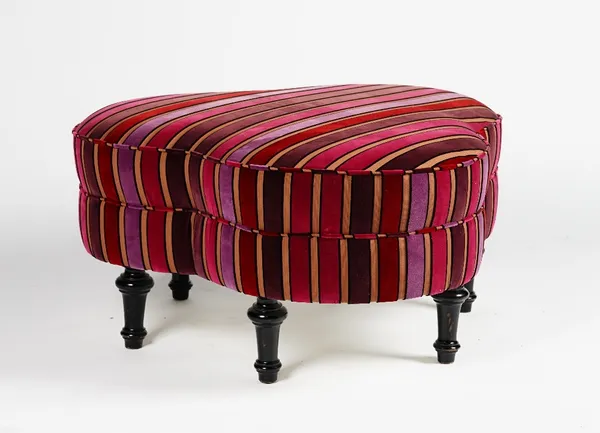 A clover-leaf shape stool, upholstered in striped velvet, on turned ebonised legs, 95cm wide x 45cm high.