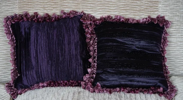 A pair of pleated silk deep purple cushions (2).