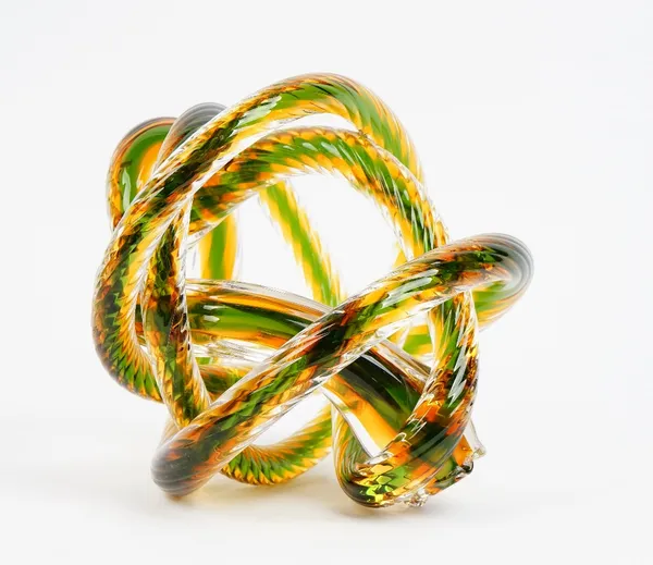 A contemporary glass sculpture of interlaced rope-twist form in clear, green and amber tint.27cm high x 25cm wide