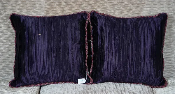 A pair of deep purple pleated silk cushions (2).