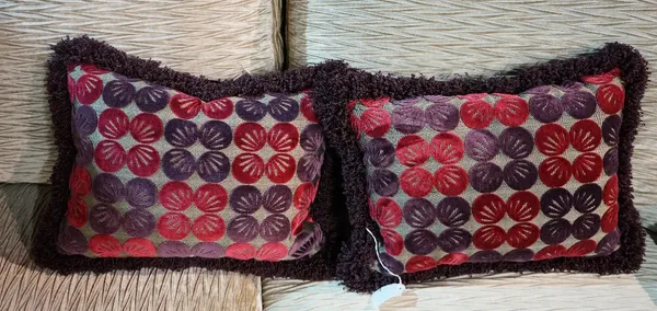 A pair of amethyst and magenta cut velvet cushions (2).
