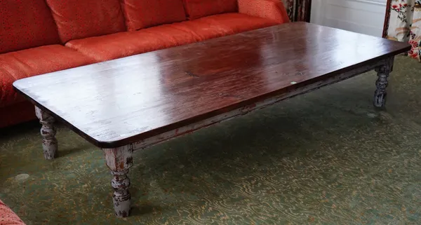 A custom made 'Vermont' cocktail table, the rectangular stained pine top, on distressed painted turned legs, 259cm wide x 48cm high.