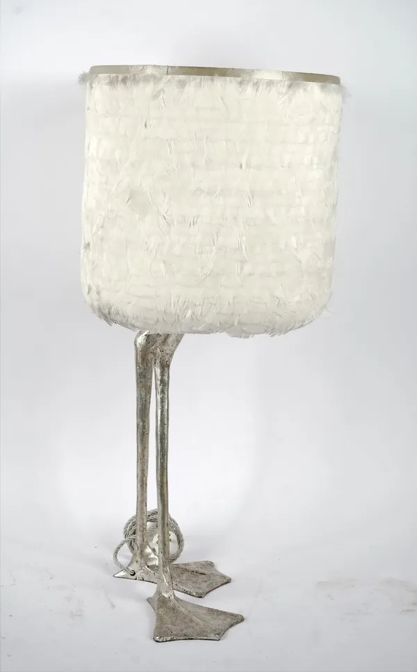 A contemporary whimsical table lamp, modelled as two duck feet with a scratched silver finish and goose feather shade.65cm tall x 33cm wide