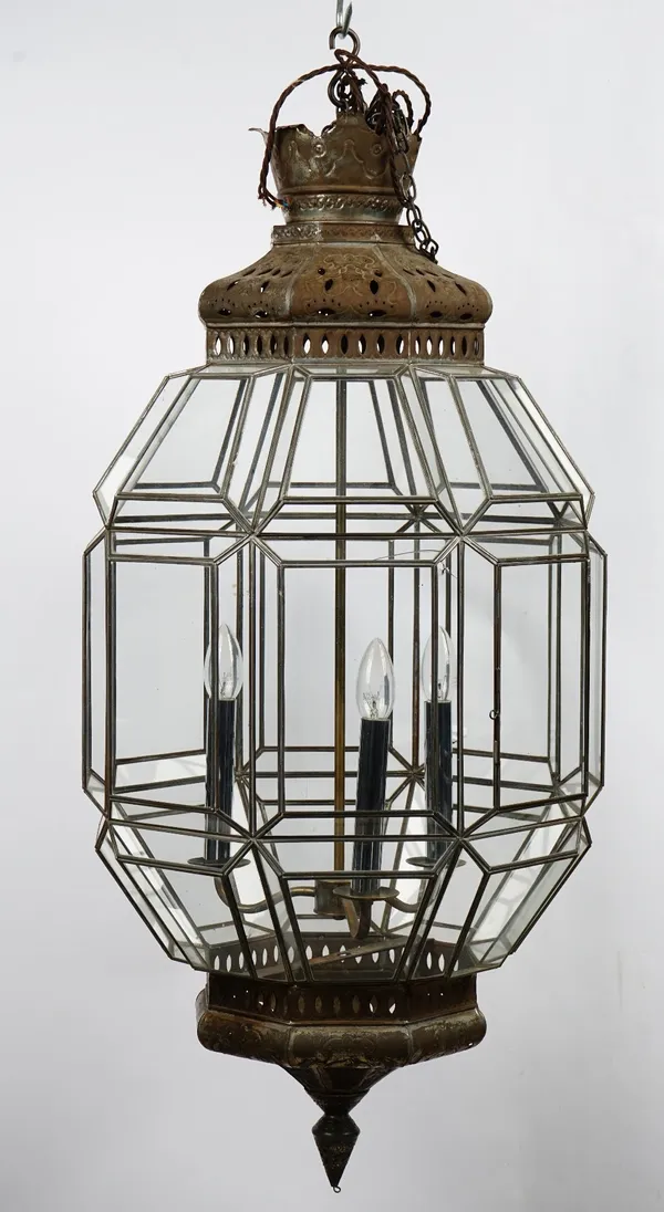 A silvered metal octagonal hanging lantern of three lights in a Moorish style, with glazed sides, 45cm wide x 100cm high.