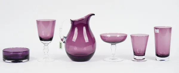 A suite of William Yeoward amethyst coloured glassware for six persons, the wine glasses only five, in five graduated sizes, together with a water pit