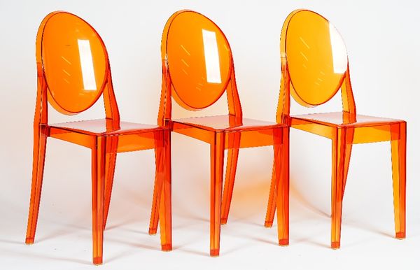 A set of eight Kartell orange lucite 'Ghost' chairs, S + ARCK by Victoria Kartell, 32cm wide x 91cm high, (8).