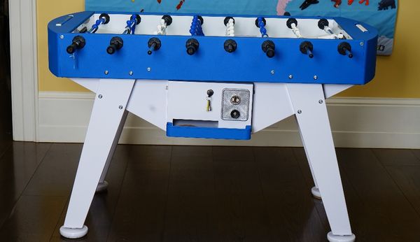 An Italian table football game, coin operated, in blue and white, 145cm wide x 89cm high.