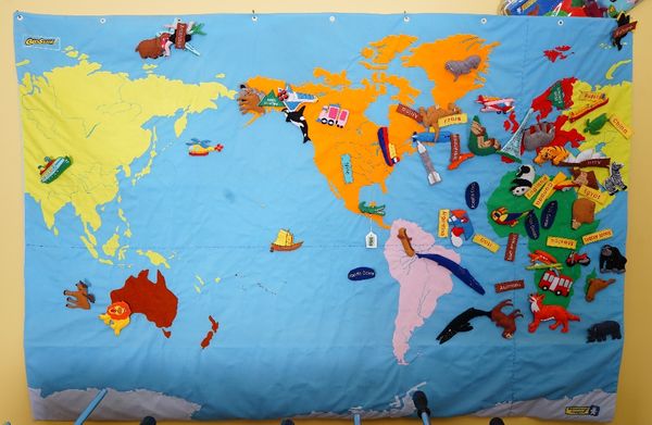 A Geo Safari Educational Insights map of the world with velcro animals and vehicles.